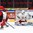 HELSINKI, FINLAND - JANUARY 3: Switzerland's Calvin Thurkauf #12 scores a second period goal on Belarus' Vladislav Verbitski #25 with Dario Meyer #14 in front during relegation round action at the 2016 IIHF World Junior Championship. (Photo by Matt Zambonin/HHOF-IIHF Images)

